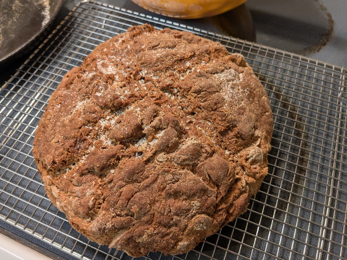 A circular loaf of bread with flaky salt on top.