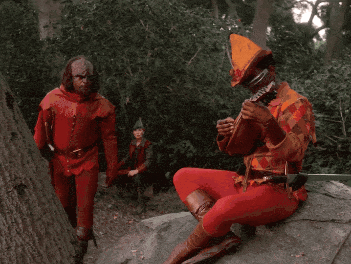 Worf from Star Trek grabbing a lute being played by Geordi and smashing it on a tree