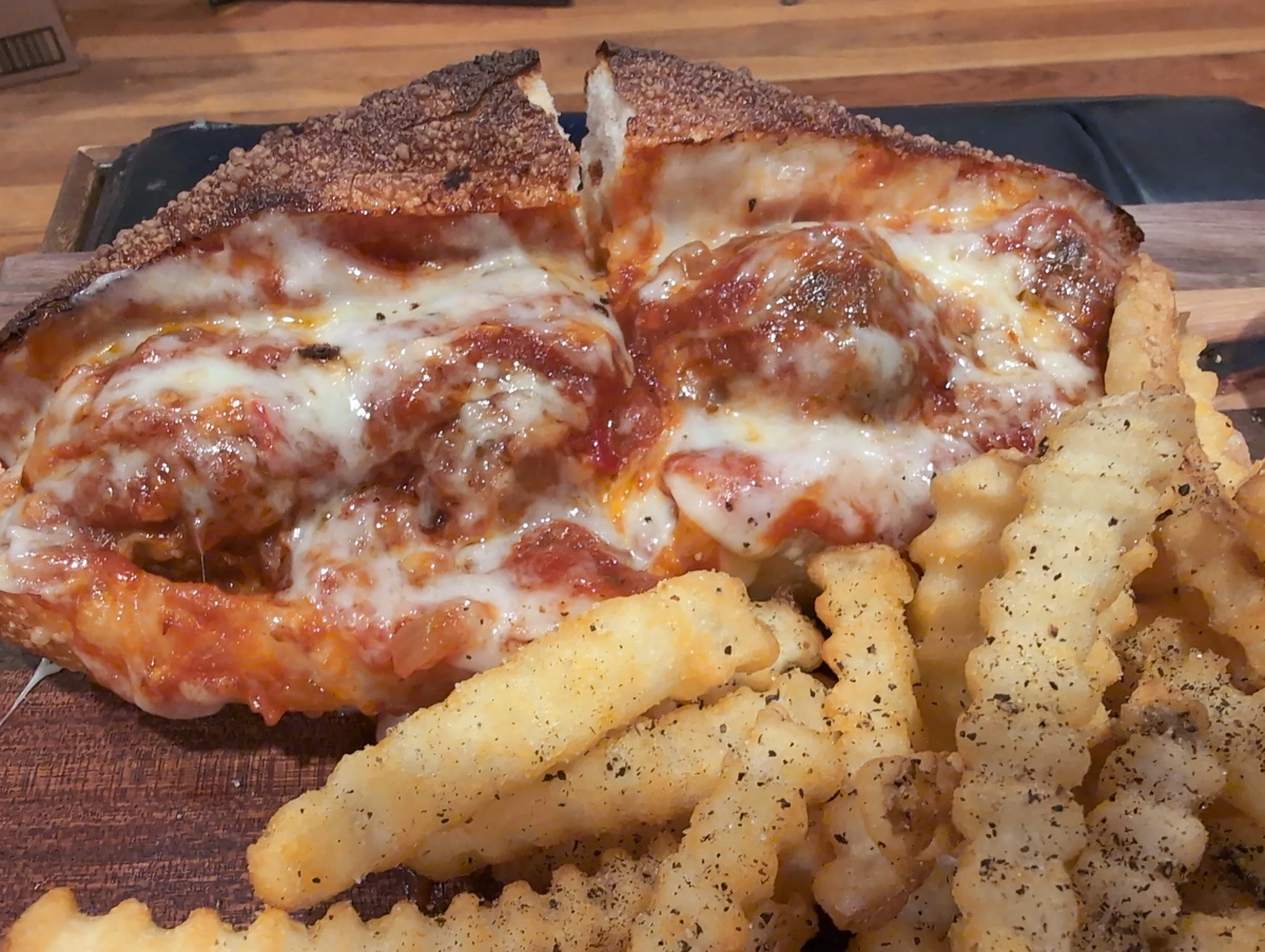 Meatball grinder and crinkle-cut french fries